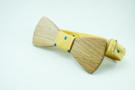 Stylish wooden bowtie with blue soft cloth ribbon. Isolatedの写真素材