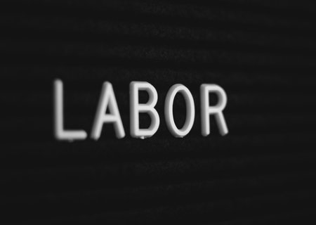 Word labor written on the letter board. White letters on the black backgroundの写真素材