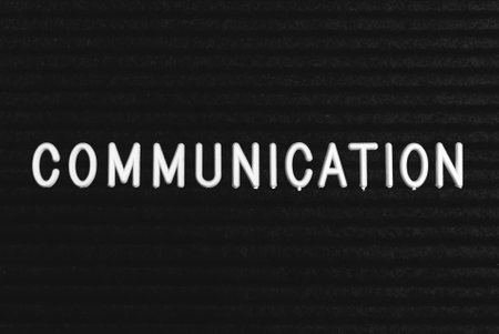 Word communication written on the letter board. White letters on the black backgroundの写真素材