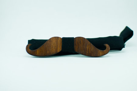 Stylish brown wooden bow tie with black soft cloth ribbon. Isolatedの写真素材
