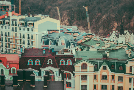 City of Kyiv (Kiev), capital of Ukraine, panorama. Colorful houses of Vozdvizhenka (Vozdvizhenska) elite district. Kitsch. Cloudy spring afternoon. Wet rooftops. Vintage colorsの写真素材