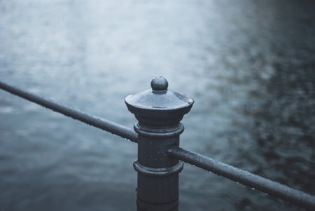 Raindrops on handtrail near Spree river in Berlin, Germany. Dark blue tonesの写真素材