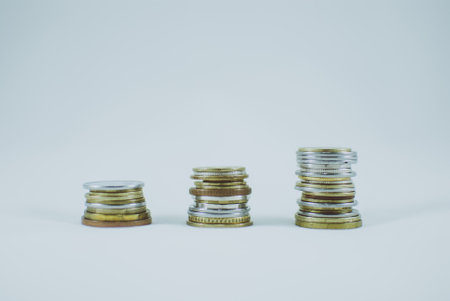 Pile of coins on white background, isolated. Abstract concept of money, savings, capitalism, economy, banking, and development.の写真素材