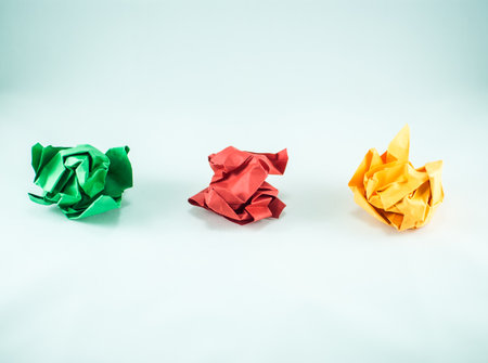 Colorful crumpled paper balls on the white background, isolated. Abstract concept of idea, innovation, creativity, imagination, success, and diversity.の写真素材