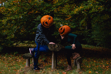 A young couple posing in pumpking head jack o lantern costumesの写真素材
