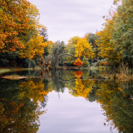 Reflection of a famous RakotzbrÃ¼cke bridge in water on a calm Autumn morning