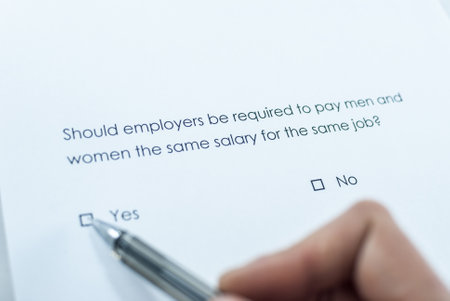 Survey question: Should employers be required to pay men and women the same salary for the same job? Answer: Yes.の写真素材