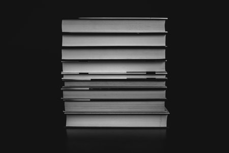 Heap of books on the cork board. Closeup of pages. Abstract concept of knowledge, education, learning, and literature. Black and whiteの写真素材