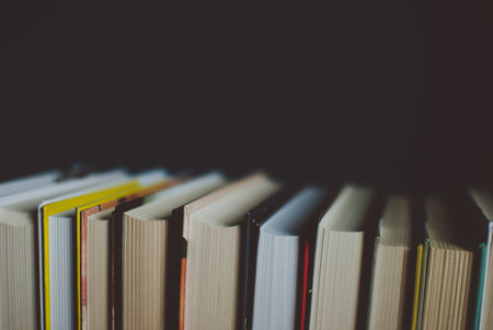 New books on the dark blue background. Closeup of counterfoils. Abstract concept of knowledge,...