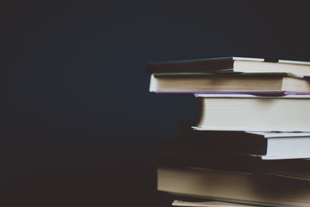Tower of colorful books on the table. Closeup of pages. Abstract concept of knowledge, education, learning, and literature. Filterの写真素材