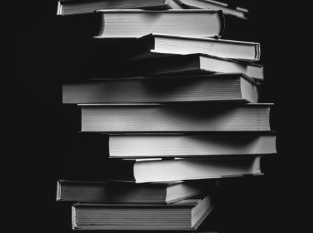 Tower of books on the table. Closeup of pages. Abstract concept of knowledge, education, learning, and literature. Black and whiteの写真素材