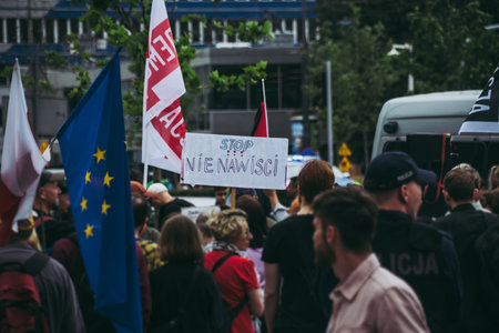 Warsaw, Poland â July 19, 2025. A banner with the slogan "STOP HATE" and a European Union flag displayed during a left-wing rally held near a simultaneous right-wing protest against immigration.の写真素材