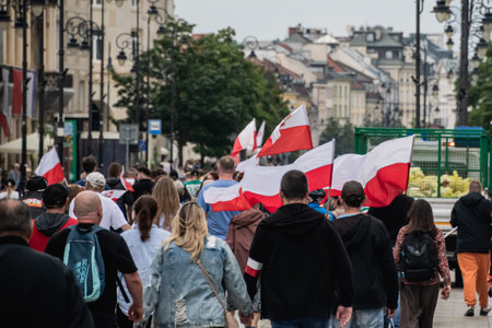Warsaw, Poland â July 19, 2025. Nationalist protesters march through the streets of Warsaw with Polish flags and banners during an anti-immigration demonstration organized by right-wing groups.の写真素材