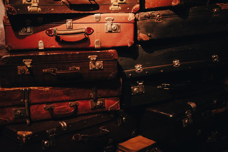 A stack of worn suitcases symbolizing displacement, migration, and human stories tied to conflict...