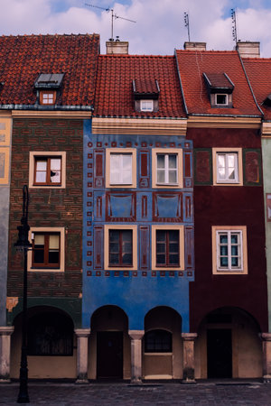 A row of vividly painted townhouses in PoznaÅ„'s Old Market Square showcases the charm of Polish...