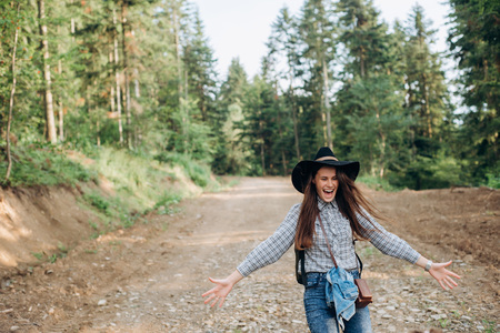 Incredibly happy girl against the background of the forest. the concept of travelers, the place for the text, the atmospheric epic momentの写真素材