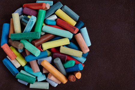 pieces of color chalk on dark backgroundの写真素材