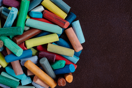 pieces of color chalk on dark backgroundの写真素材