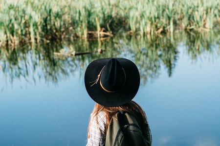 Girl traveler on the water backgroundの写真素材