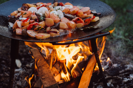 Cooking vegetables and food over an open fire on outdoor.の写真素材