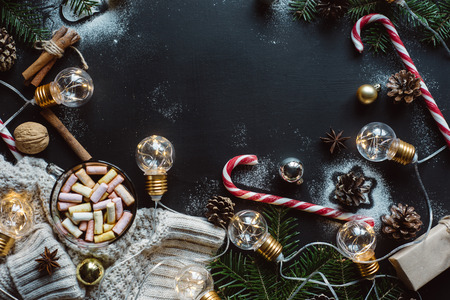 Christmas flat lay. Chocolate or cocoa with marshmallow, cookies, candy on a dark background.の写真素材