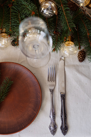 Table with Christmas decorations and green spruce branchesの写真素材