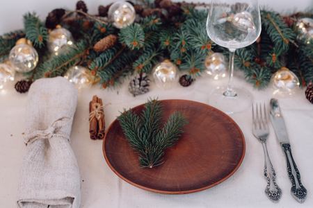 Table with Christmas decorations and green spruce branchesの写真素材