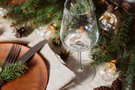 Table with Christmas decorations and green spruce branchesの写真素材