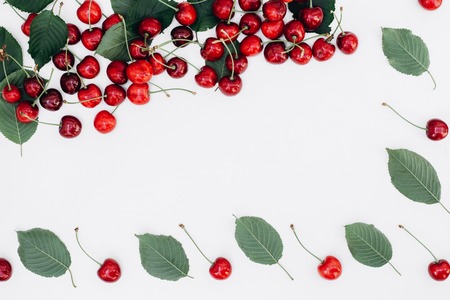 Fresh red cherry and leaf pattern on white background. Concept of healthy eating. Flat lay, top...