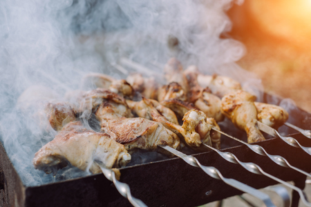 Closeup photo of preparation barbecue grill with chicken meat on outdoor in time summer. Cooking food in natureの写真素材