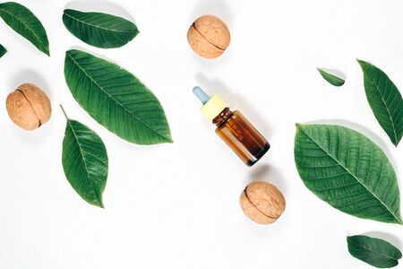 Cosmetic and medicinal oil of walnut on white background. Natural Serums. Flat lay, top view, copy spaceの写真素材