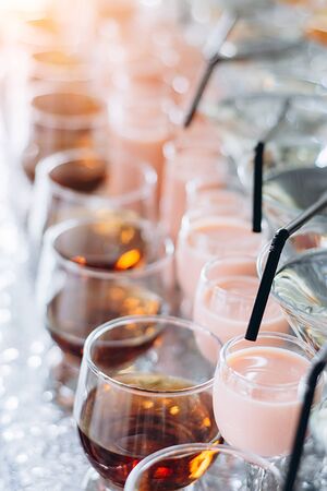 Festive table with cold exotic alcoholic beverages, cocktails. Party and holiday celebration concept