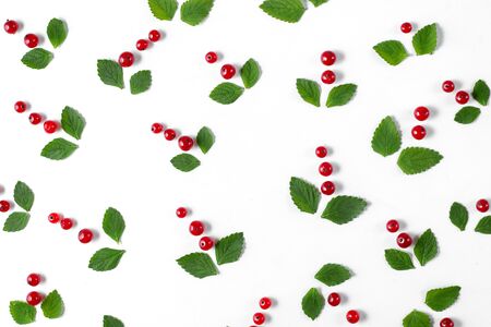 Fruit pattern made of fresh berries and green leaves on white background. Concept of healthy food. Flat lay, top view, copy spaceの写真素材