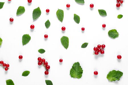 Fruit pattern made of fresh berries and green leaves on white background. Concept of healthy food. Flat lay, top view, copy spaceの写真素材