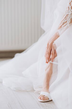 Beautiful female feet closeup. Bride dresses shoes before the wedding ceremony. Wedding bride shoes.の写真素材
