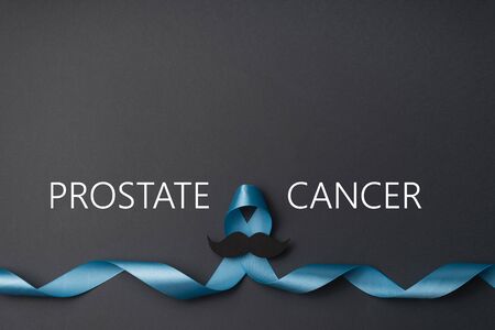 Symbol for support men. Top view on blue Ribbon with mustache for supporting people living and...