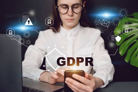 Close up front view young woman holding smartphone, with text GDPR. Data Protection Regulation,...