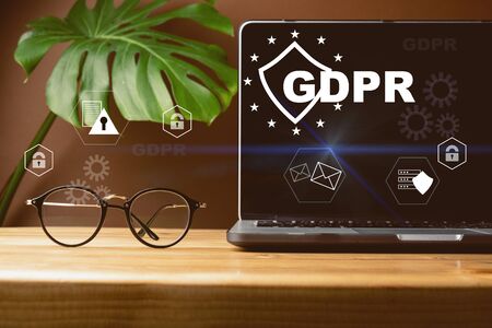 Front view of blank screen laptop, sign general data protection regulation GDPR and shield with key...