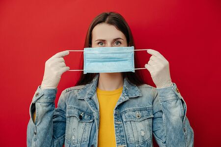 Young woman protects face with mask, thinks abot risk of epidemic disease, has virus infection,...