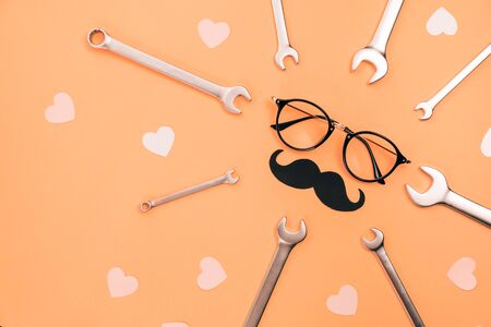 Holiday concept made with eyeglasses, stylish black paper photo booth props moustaches, many little...