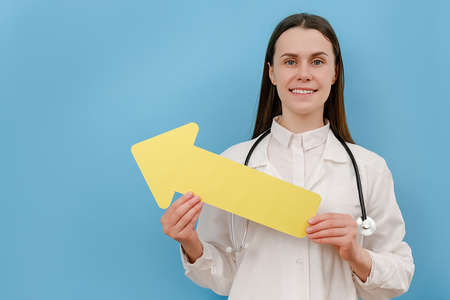 Portrait of sweet confident age woman therapist dressed white coat and stethoscope holding yellow...