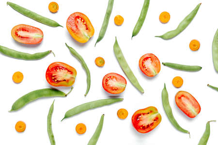 Creative layout made of haricot, tomatoes and carrots on white studio background wall. Flat lay, top view, copy space. Healthy, Shopping food supermarket conceptの写真素材