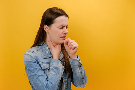 Portrait of sick unhappy young Caucasian woman having cough and feeling pain in lungs, catching...