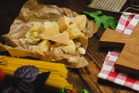 Pasta background. Dry spaghetti with vegetables and herbs on a wooden table.の写真素材
