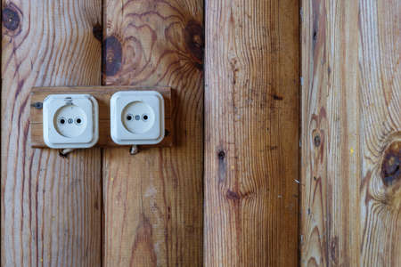 old electricity switch on a wooden wallの写真素材