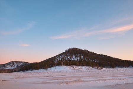 beautiful winter sunset against the backdrop of mountains