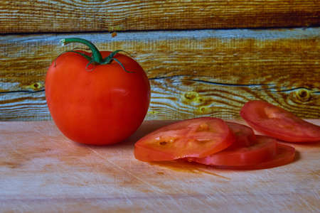 Delicious tomatoes on a chopping boardの写真素材