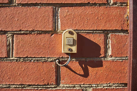 old doorbell on a brick wall