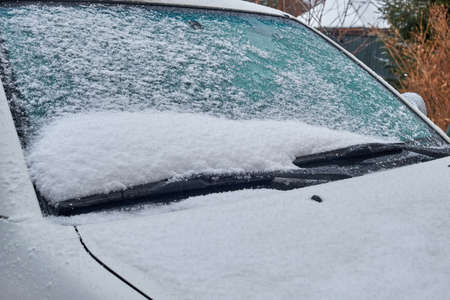 car glass covered with fallen fresh snowの写真素材