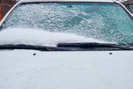 car glass covered with fallen fresh snowの写真素材